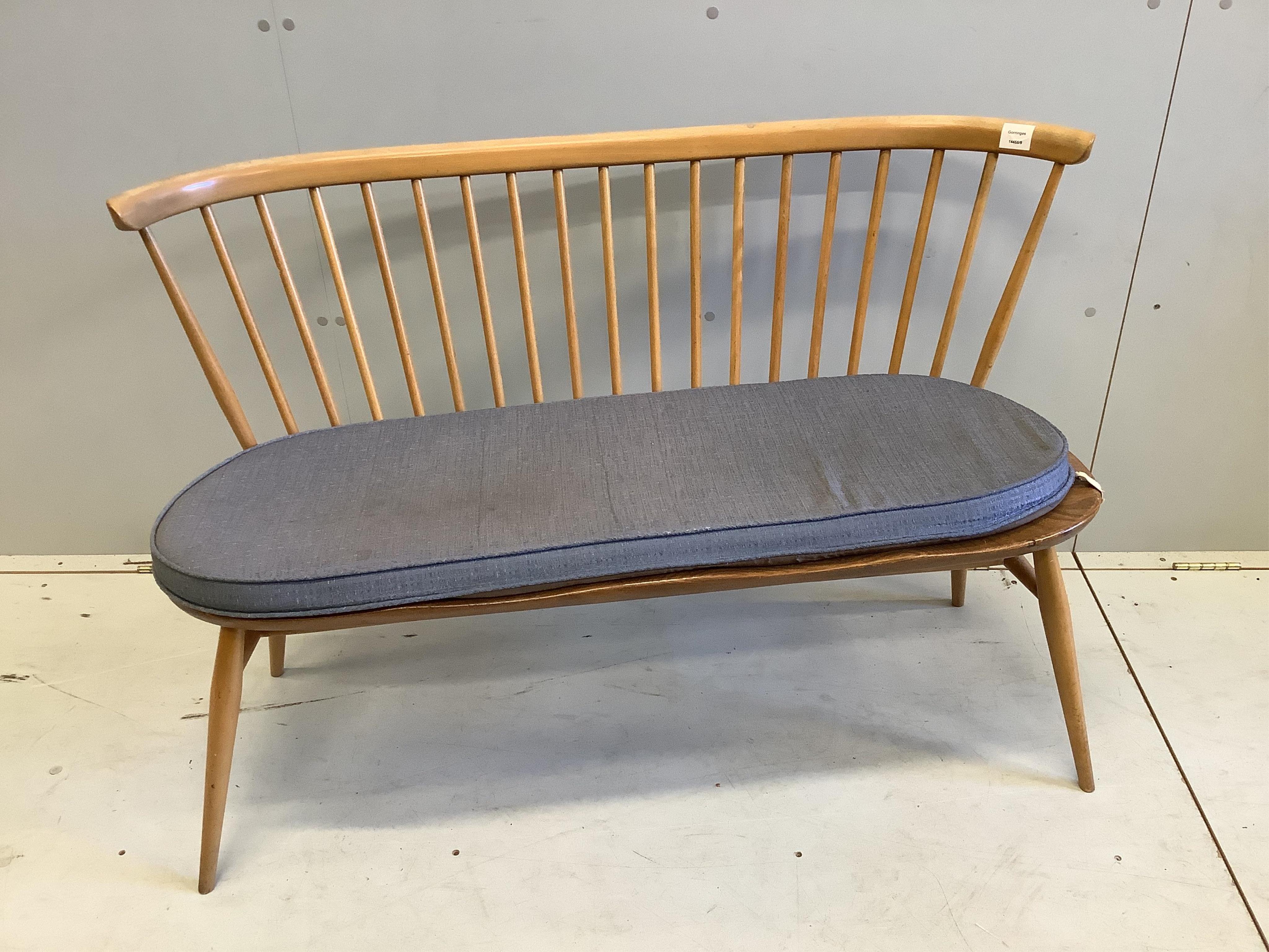 An Ercol elm and beech comb back bench with squab cushion seat, width 112cm, depth 44cm, height 78cm. Condition - fair